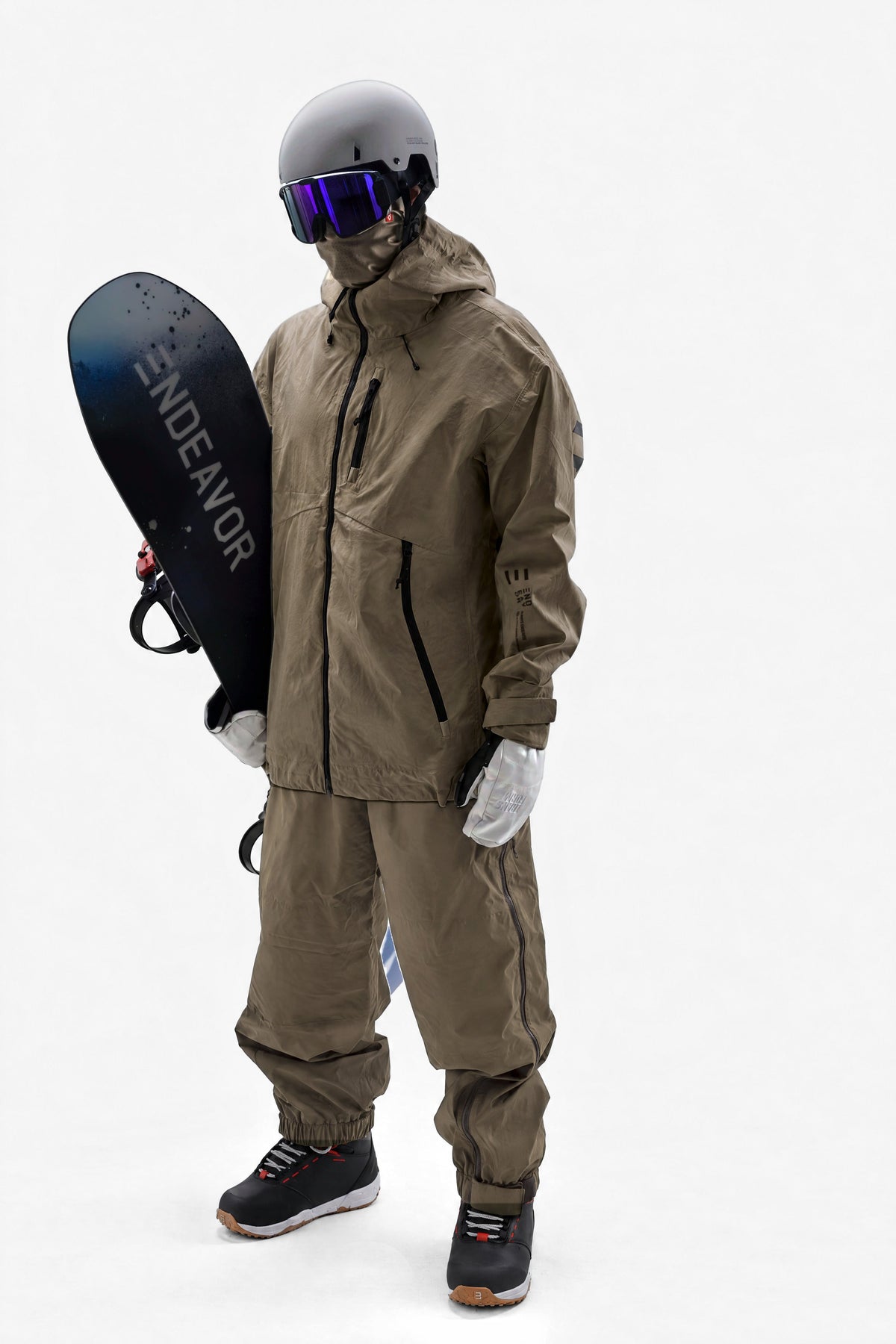 Kit 01: rider in the Endeavor 3L Shelter Jacket and 2L Ranger Pant in Algae, Sandbox Icon helmet and goggle, Airhole balaclava, Transform mitts, Scout boots, Scout Pro snowboard and Scout bindings
