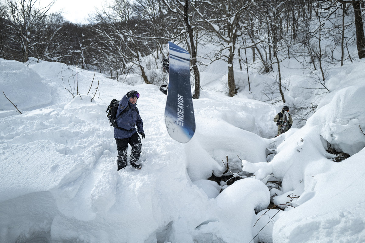 Endeavor Scout Pro snowboard held up in the snow, base showing, Japan