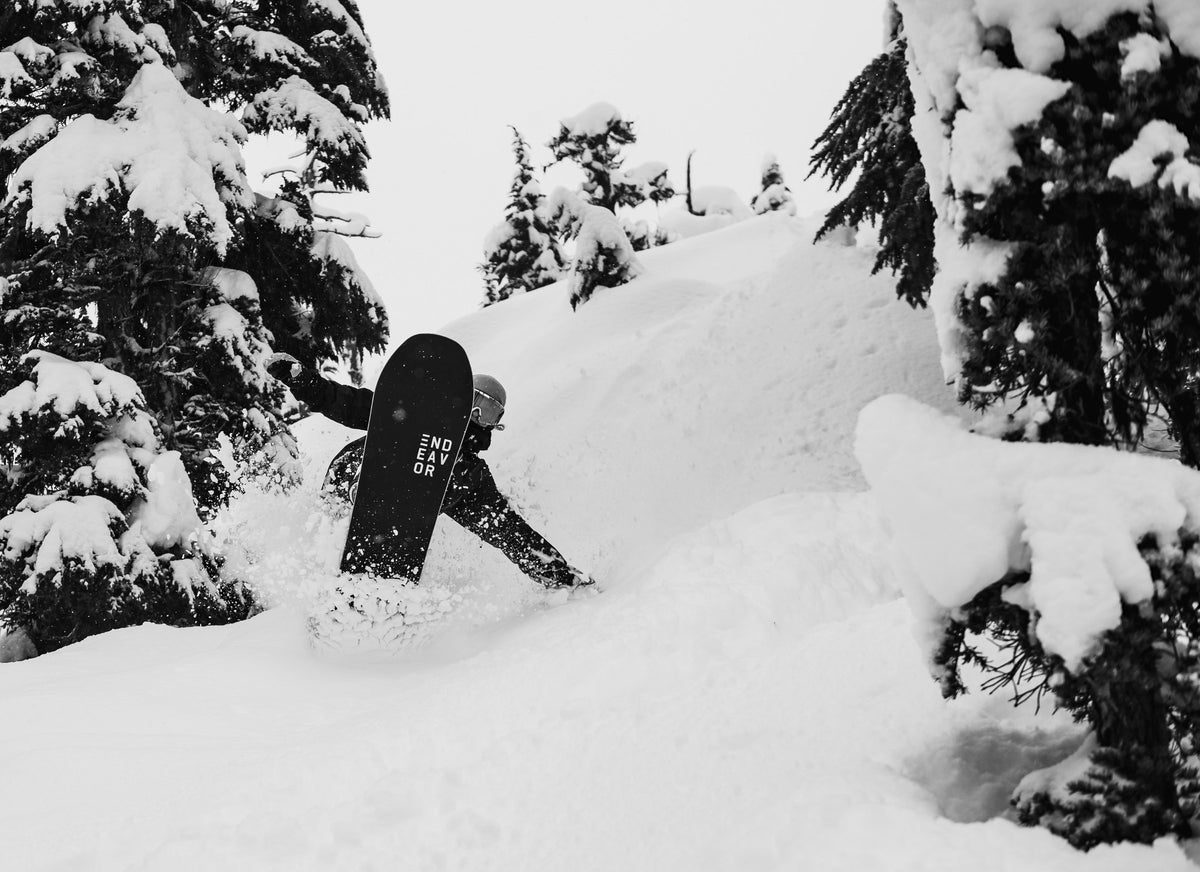 Endeavor Scout Pro Black snowboard in deep powder, base showing