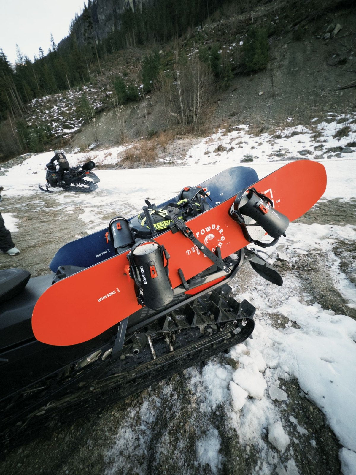 Endeavor Trooper Pro snowboard with bindings on a snowmobile rack
