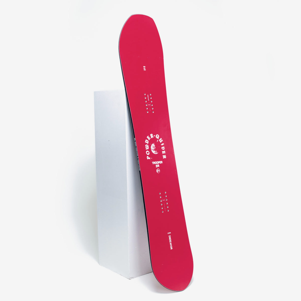 Endeavor Trooper Pro snowboard leaning on a studio plinth, topsheet