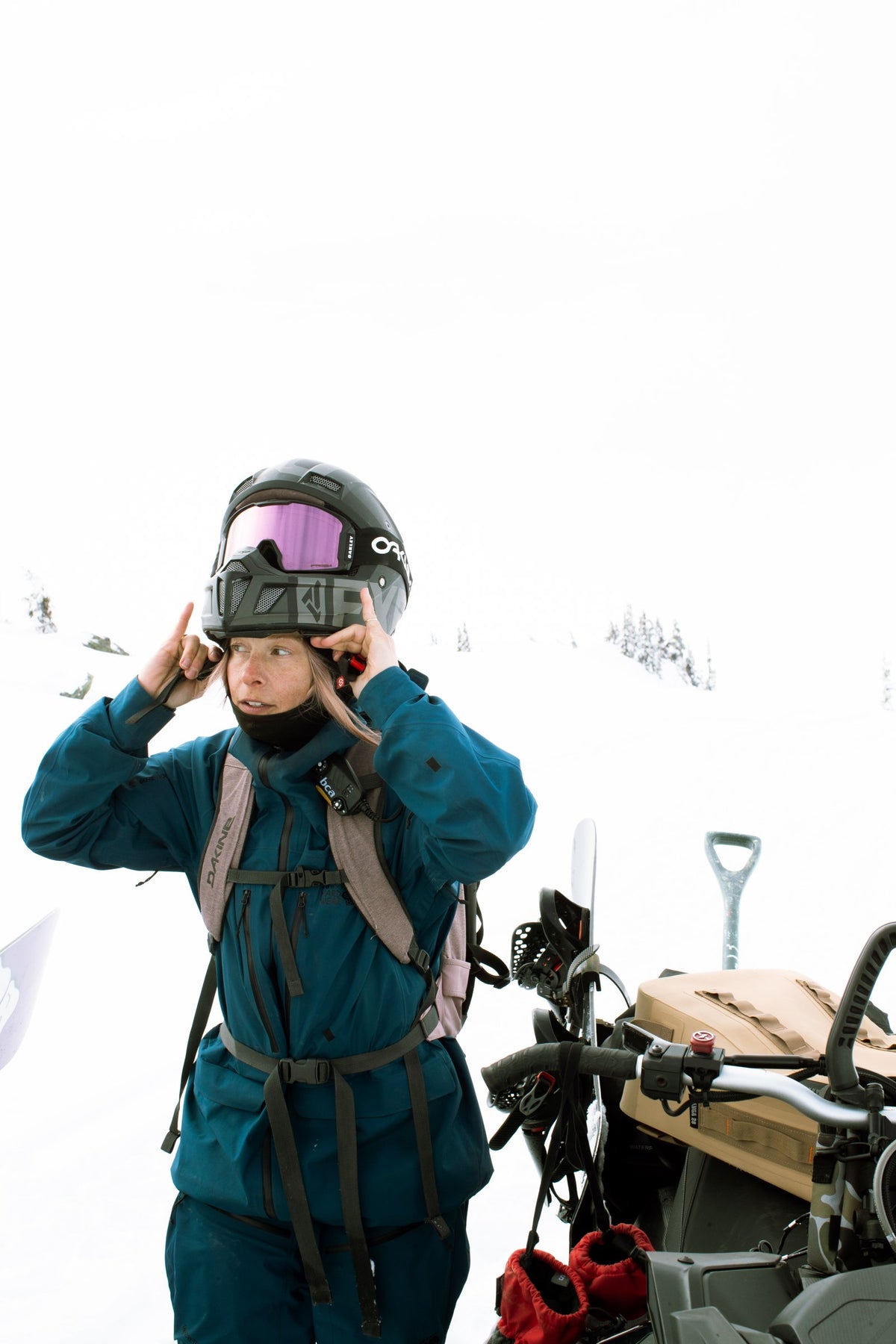 Rider in a black Airhole merino balaclava pulling on her helmet