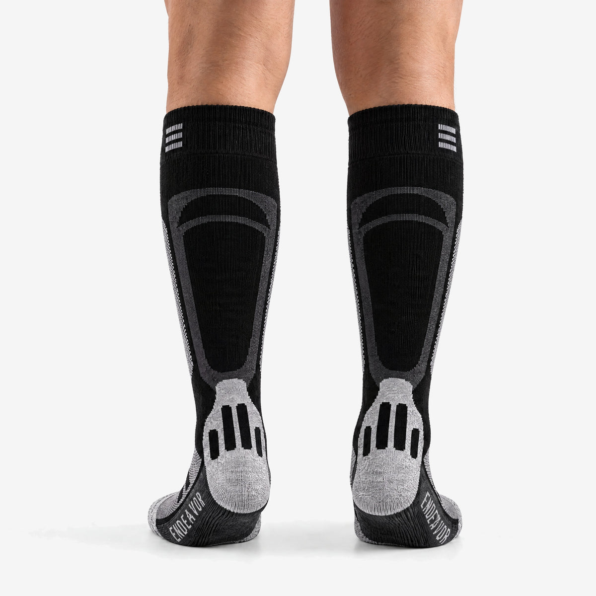 Endeavor Surplus Sock in black, worn, back view with the heel and ENDEAVOR on the sole