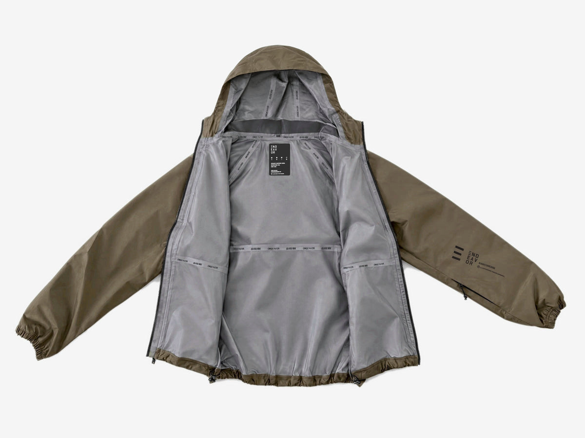 Endeavor 20K Windbreaker in Algae, laid open showing the grey lining, printed seam tapes and inner label