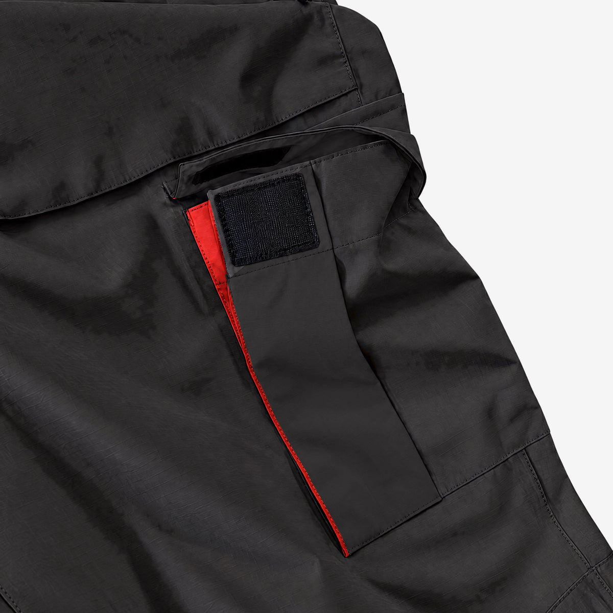 Endeavor 2L Patrol Cargo Pant in Black, cargo pocket with its flap lifted and the hook-and-loop tab