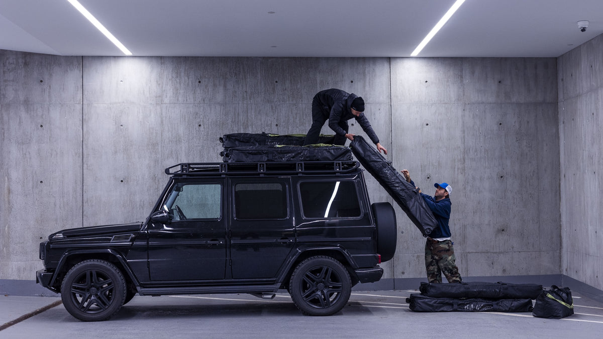 Riders loading Endeavor snowboard bags onto a roof rack