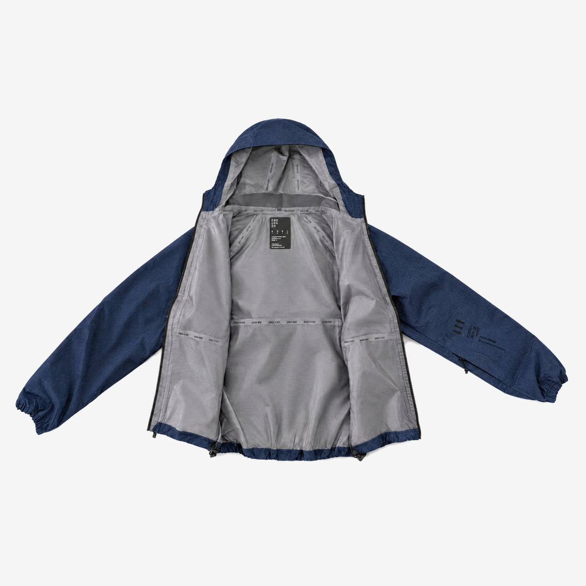 Endeavor 20K Windbreaker Limited Edition in Raw Denim, laid open showing the grey lining, printed seam tapes and inner label