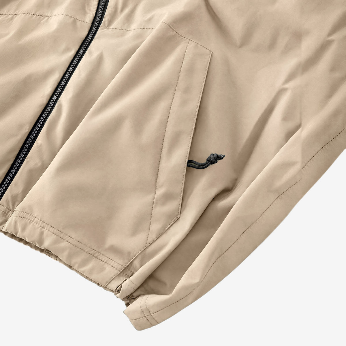 Endeavor 20K Windbreaker in Fiber, zipped hand pocket with cord pull