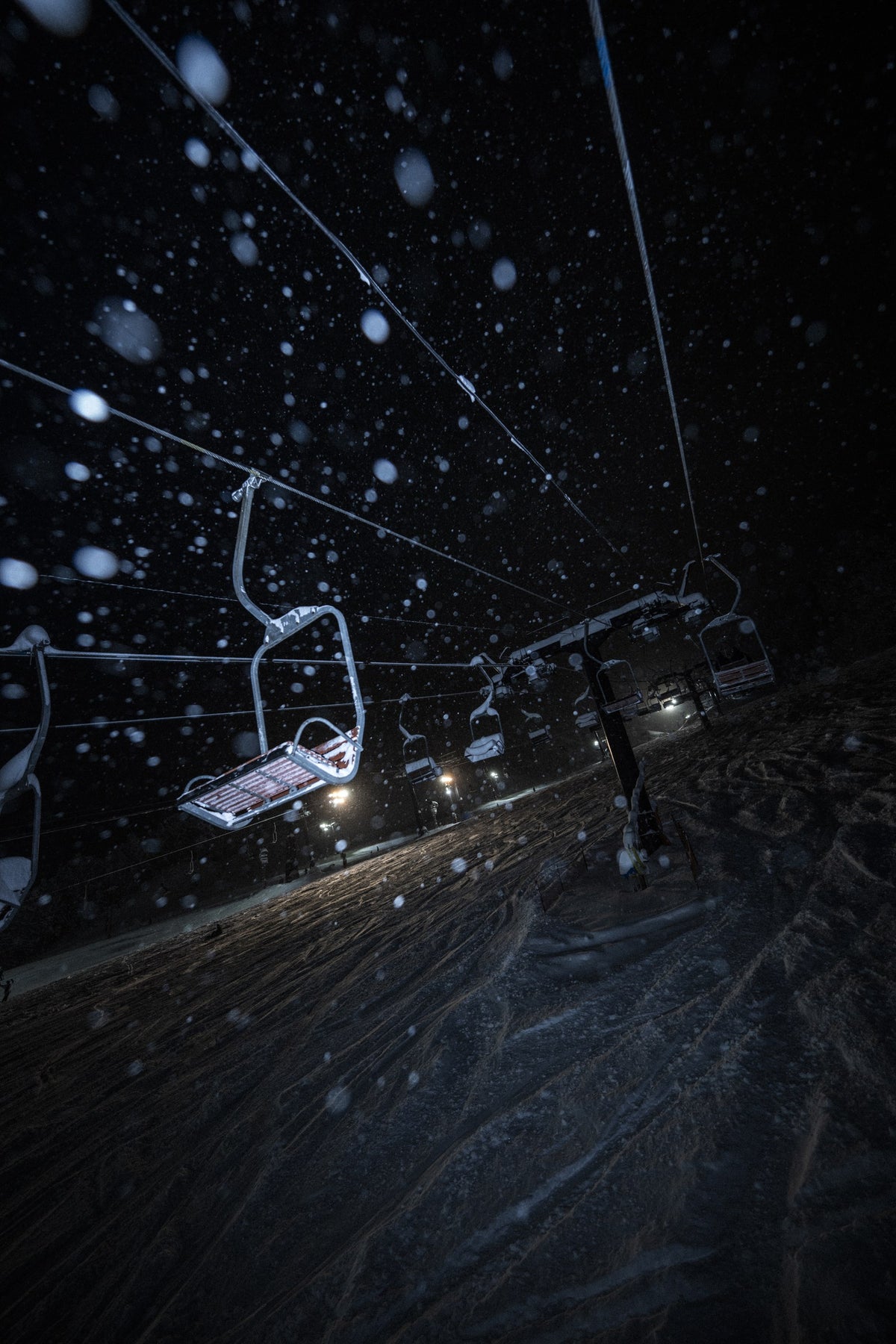 Night chairlift in falling snow