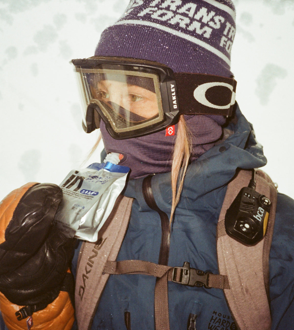 Rider in goggles and a purple Airhole facemask on a snowy day