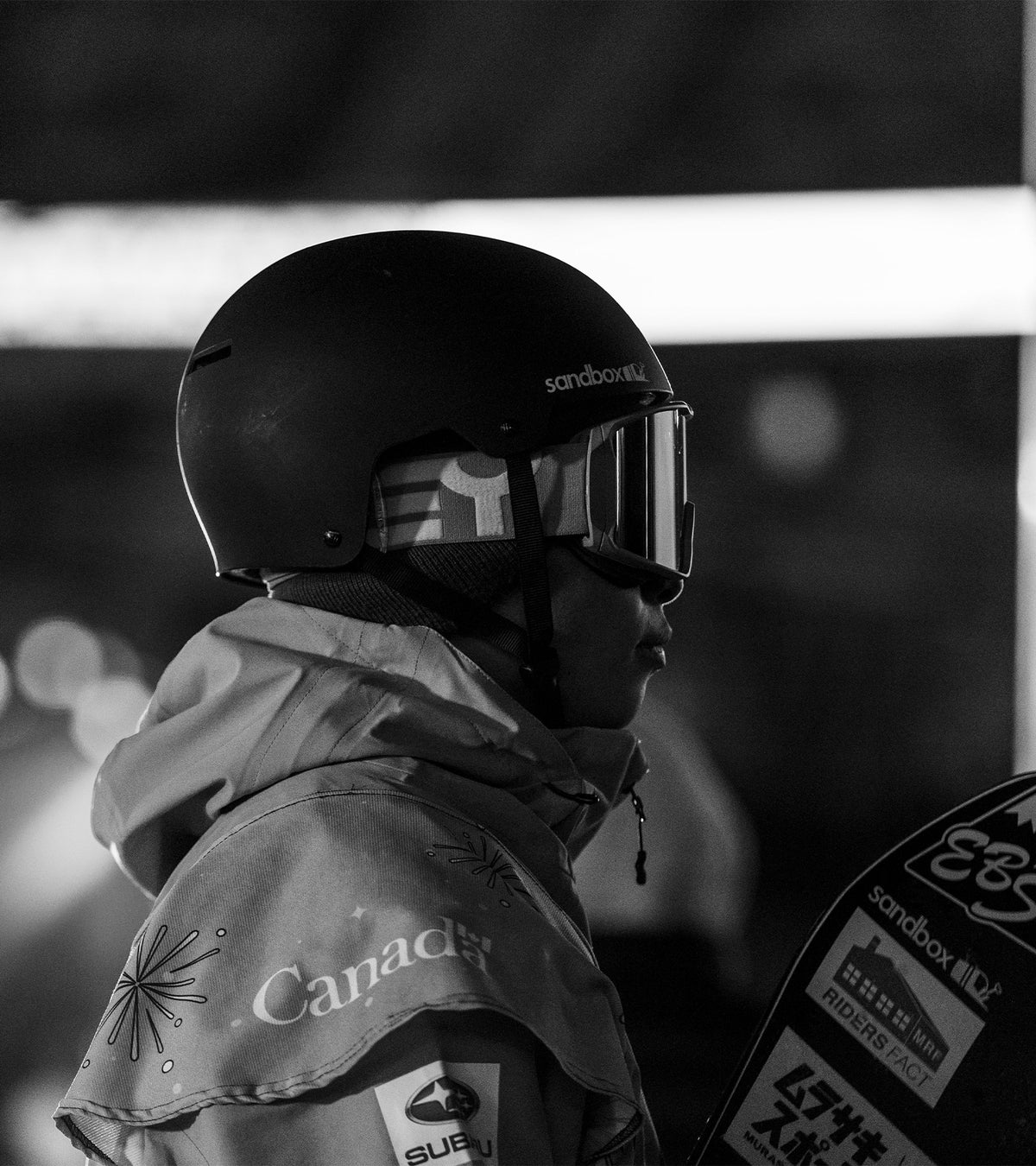 Rider in a black Sandbox helmet and goggles, side profile