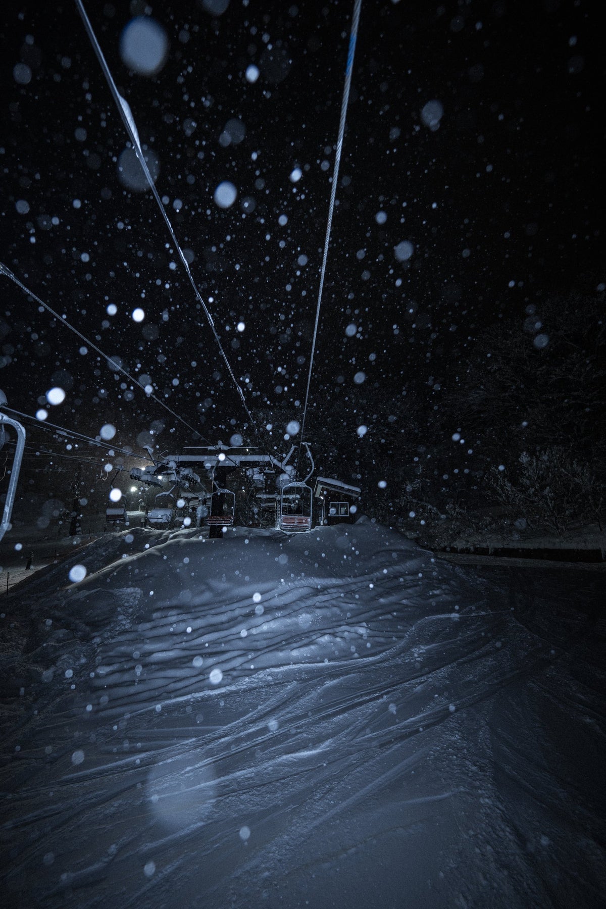 Empty chairlift in a night snowstorm